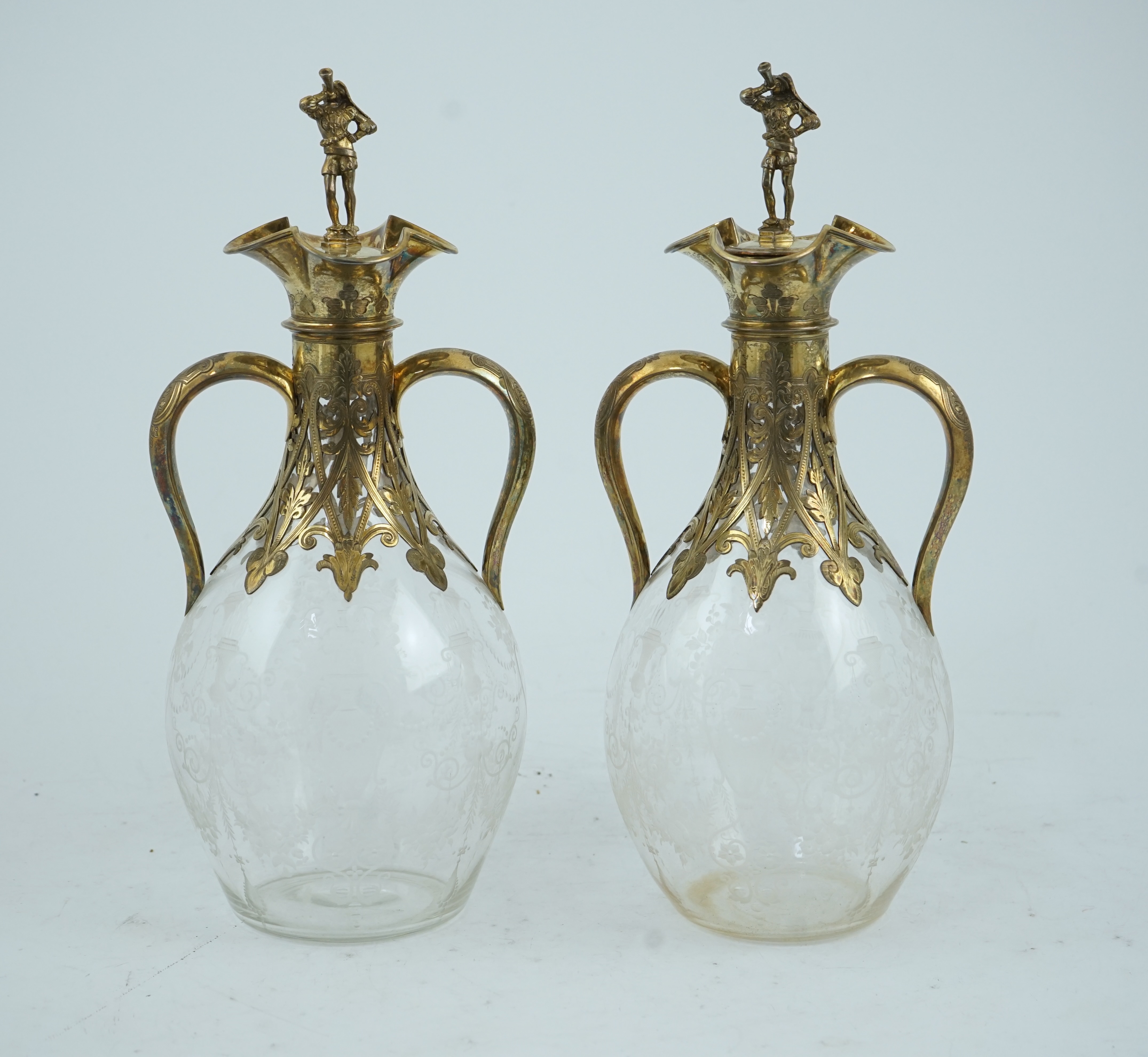 A good pair of Victorian silver gilt mounted wheel engraved glass two handled decanters and stoppers, by George Fox